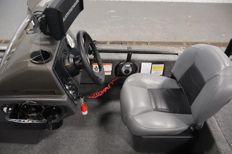 Slide: The Image of 2024 Tracker Bass Tracker Classic XL boat interior with steering wheel and seat. - 19