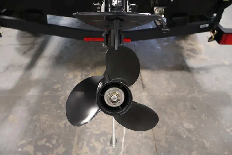 Slide: The Image of 2024 Tracker Bass Tracker Classic XL boat propeller, close-up view in a garage setting. - 44
