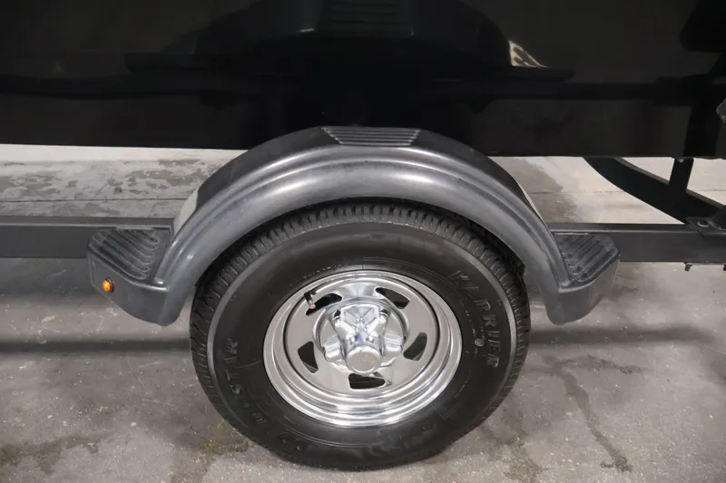 Slide: The Image of 2024 Tracker Bass Tracker Classic XL trailer wheel and fender detail. - 47
