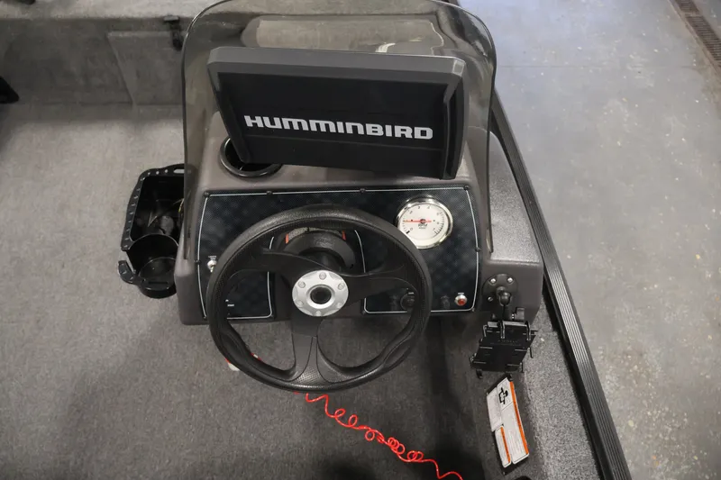 Slide: The Image of 2024 Tracker Bass Tracker Classic XL dashboard with Humminbird display and steering wheel. - 20