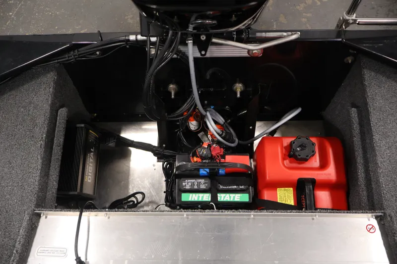 Slide: The Image of 2024 Tracker Bass Tracker Classic XL boat engine compartment with battery and fuel tank. - 37