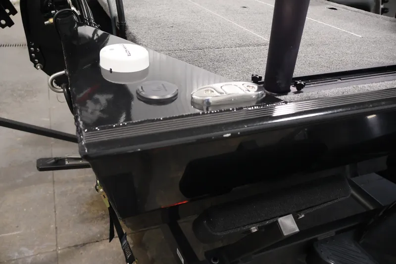 Slide: The Image of 2024 Tracker Bass Tracker Classic XL boat deck with sleek black finish and carpeted surface. - 50