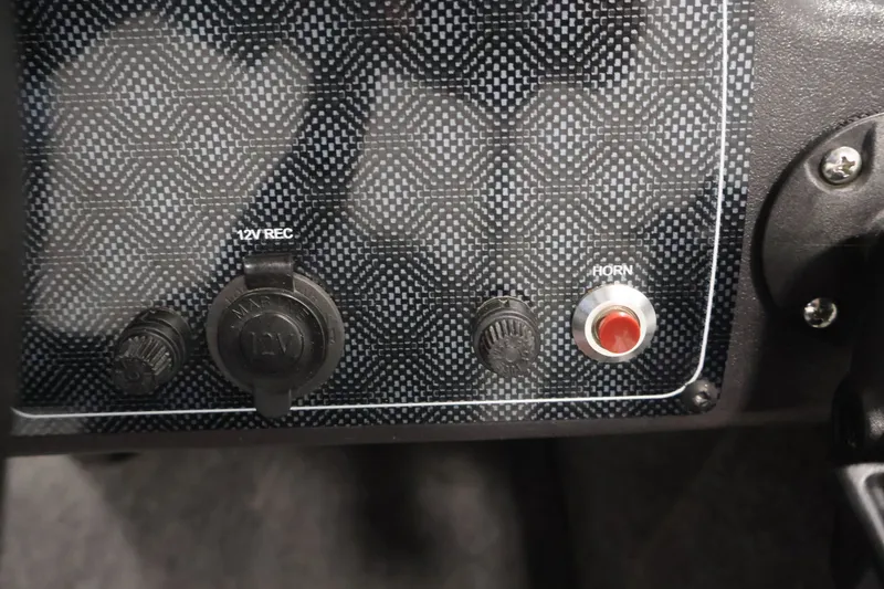 Slide: The Image of Control panel of 2024 Tracker Bass Tracker Classic XL with 12V socket and horn button. - 26