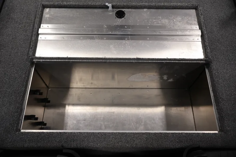 Slide: The Image of 2024 Tracker Bass Tracker Classic XL livewell interior with metal finish and carpeted edges. - 34