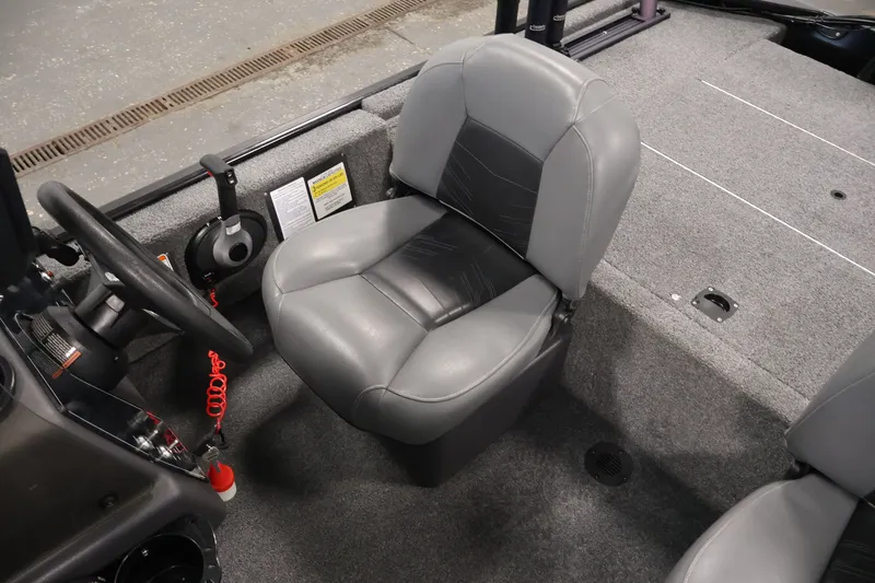 Slide: The Image of 2024 Tracker Bass Tracker Classic XL boat interior with gray seating and steering wheel. - 29