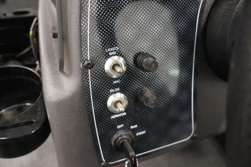 Slide: The Image of Control panel of 2024 Tracker Bass Tracker Classic XL boat with switches for lights, bilge, and aerator. - 24