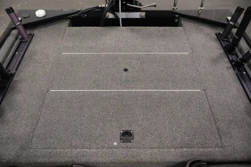 Slide: The Image of 2024 Tracker Bass Tracker Classic XL boat deck with carpeted surface and storage compartments. - 33