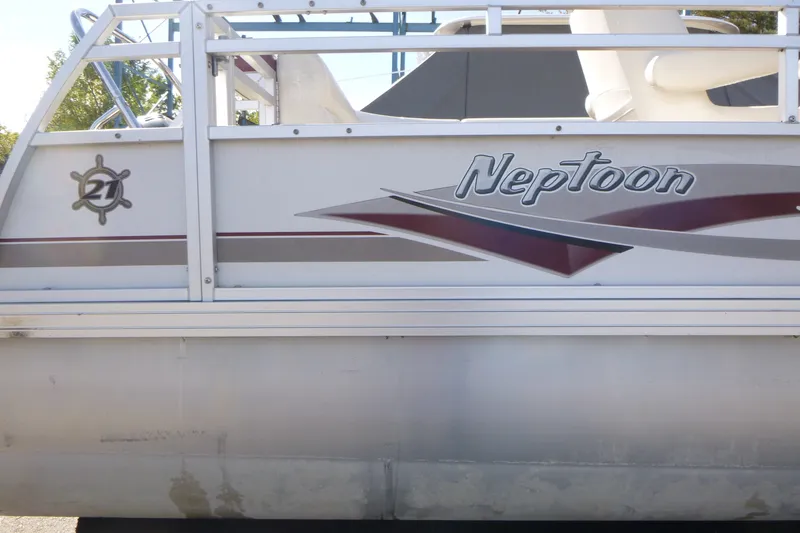Slide: The Image of 2004 J 21' Neptune boat side view with logo and design details. - 12