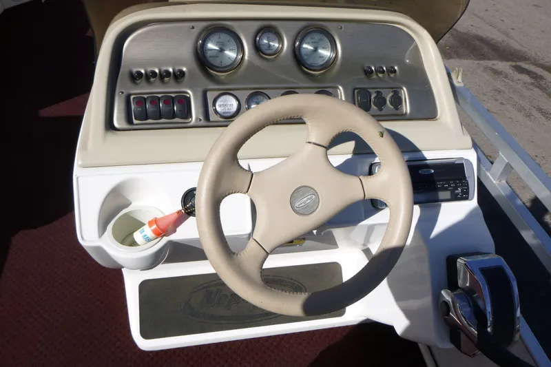 Slide: The Image of Steering console of a 2004 J 21' Neptune boat with gauges and controls. - 8