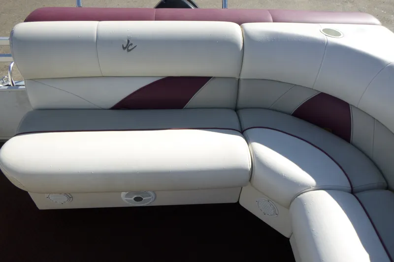 Slide: The Image of 2004 J 21' Neptune boat seating with white and maroon upholstery. - 10