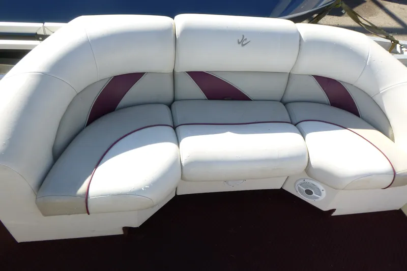 Slide: The Image of White and purple boat seating on a 2004 J 21' Neptune model. - 5