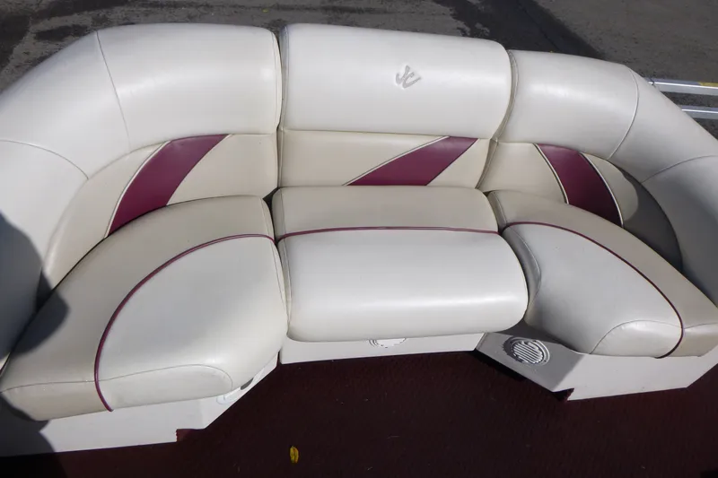 Slide: The Image of White and maroon boat seating on 2004 J 21' Neptune model. - 6
