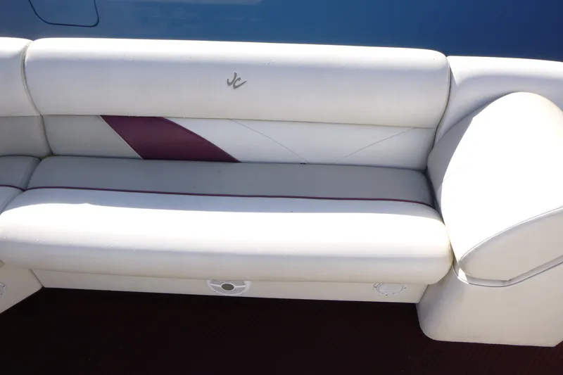 Slide: The Image of White and maroon boat seating on a 2004 J 21' Neptune model. - 9