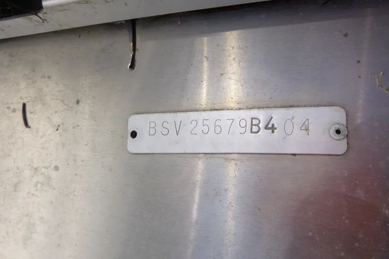 Slide: The Image of Metallic identification plate with code "BSV 25679B404" on a 2004 J 21' Neptune. - 13