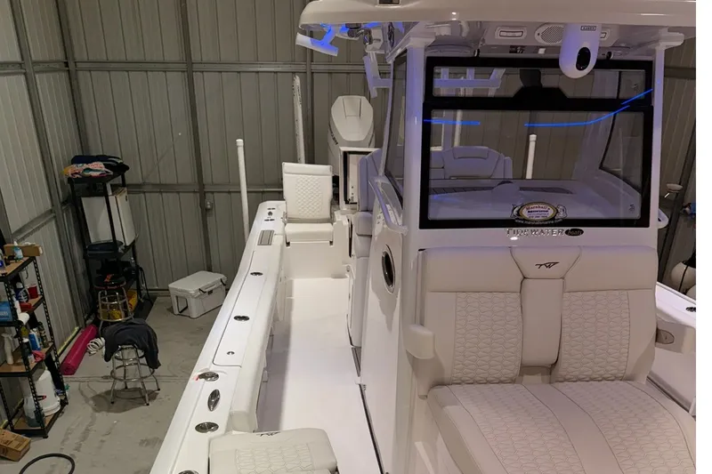 Slide: The Image of 2027 Tidewater 3100 Carolina Bay boat in a storage facility, showcasing sleek design. - 8