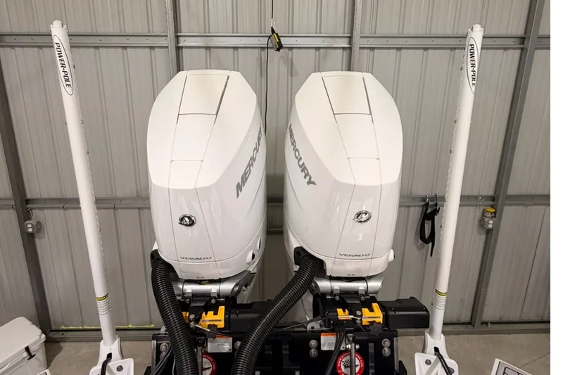 Slide: The Image of Twin Mercury outboard engines on a 2027 Tidewater 3100 Carolina Bay boat. - 17