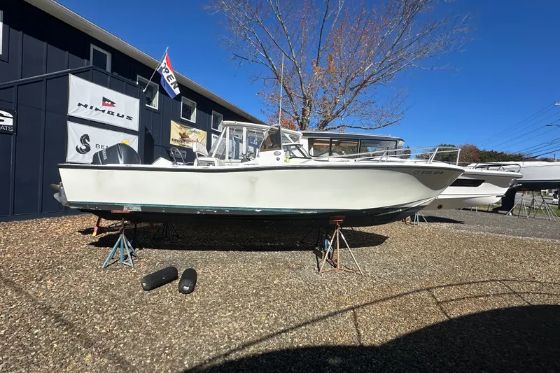 Slide: The Image of 1978 Mako 252 Center Console boat displayed outdoors on stands. - 2