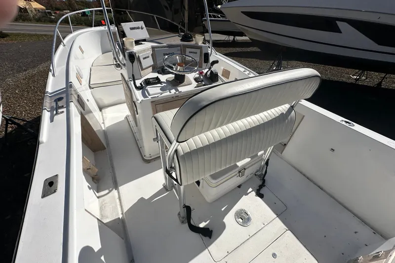 Slide: The Image of 1978 Mako 252 Center Console boat interior with steering wheel and seating. - 11