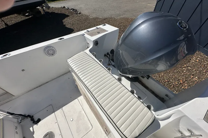 Slide: The Image of 1978 Mako 252 Center Console boat interior with outboard motor and cushioned seating. - 12