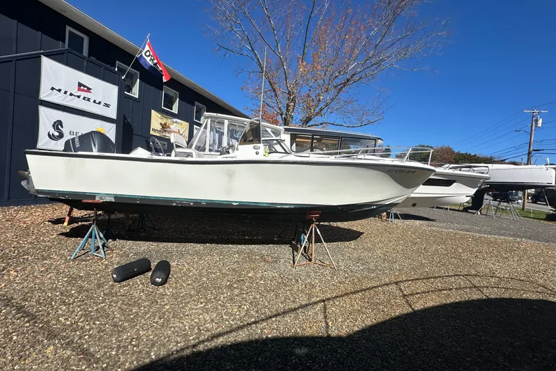 Slide: The Image of 1978 Mako 252 Center Console boat on stands, displayed outdoors under clear blue sky. - 5