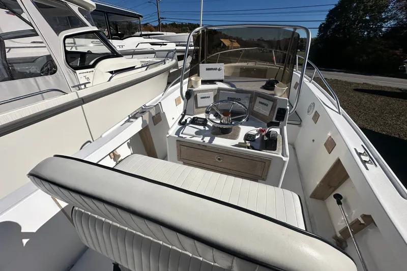 Slide: The Image of 1978 Mako 252 Center Console boat interior with steering wheel and navigation equipment. - 13