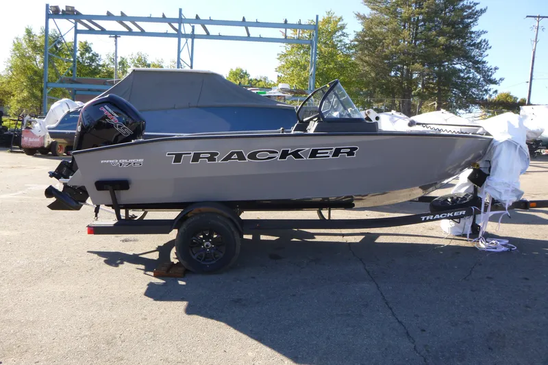 The Image of 2027 Tracker Pro Guide V-175 Combo boat on trailer, parked outdoors. - 0
