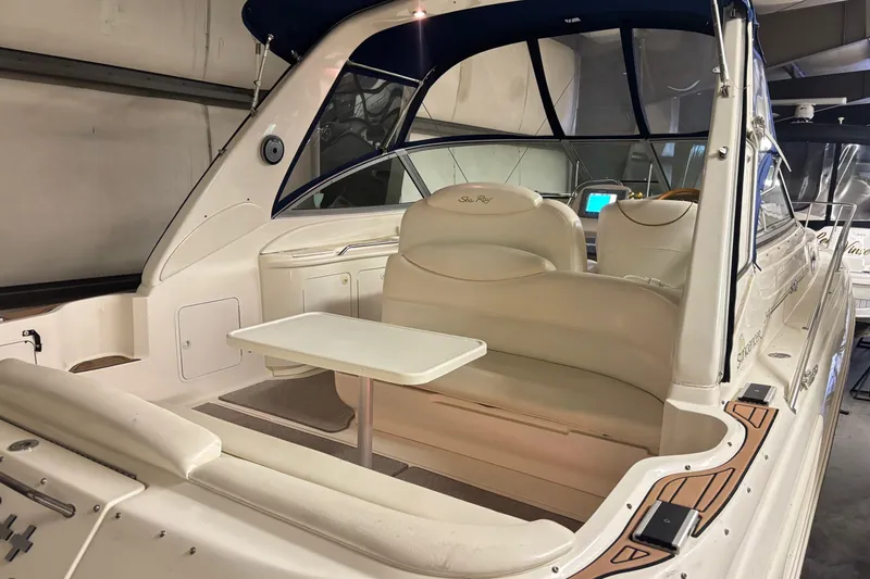 Slide: The Image of 2000 Sea Ray 340 Sundancer boat interior with seating and table in a storage facility. - 4