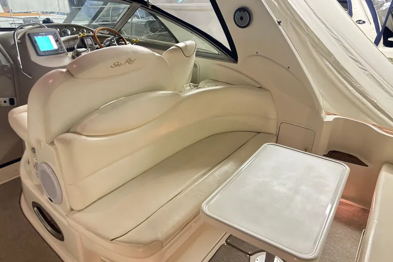 Slide: The Image of Interior of 2000 Sea Ray 340 Sundancer with cream seating and navigation controls. - 7