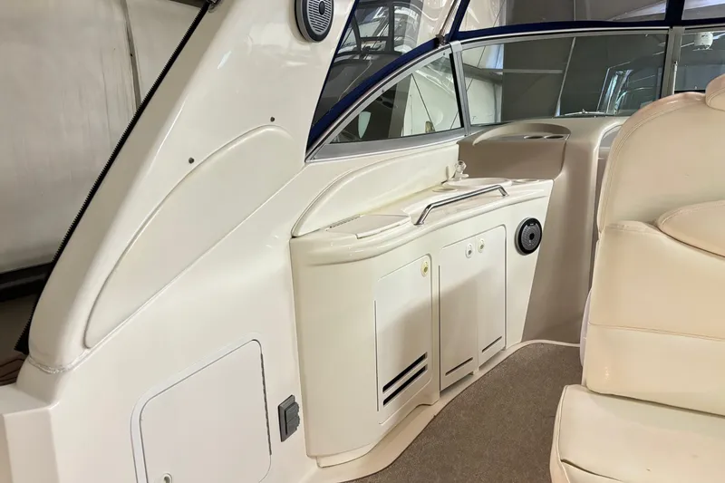 Slide: The Image of Interior view of a 2000 Sea Ray 340 Sundancer boat, featuring seating and cabinetry. - 8