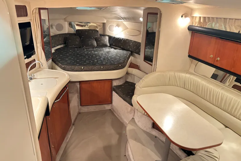 Slide: The Image of Interior of 2000 Sea Ray 340 Sundancer yacht with cozy seating and compact kitchenette. - 11