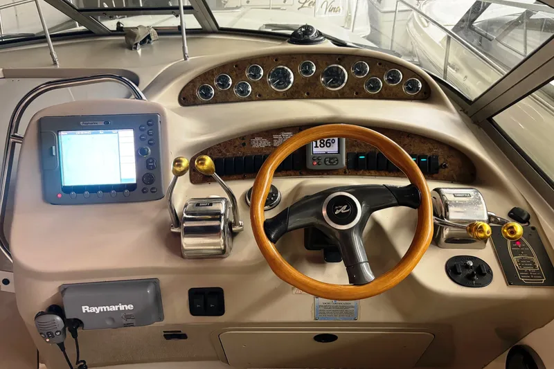 Slide: The Image of Control panel of a 2000 Sea Ray 340 Sundancer boat with steering wheel and navigation equipment. - 10
