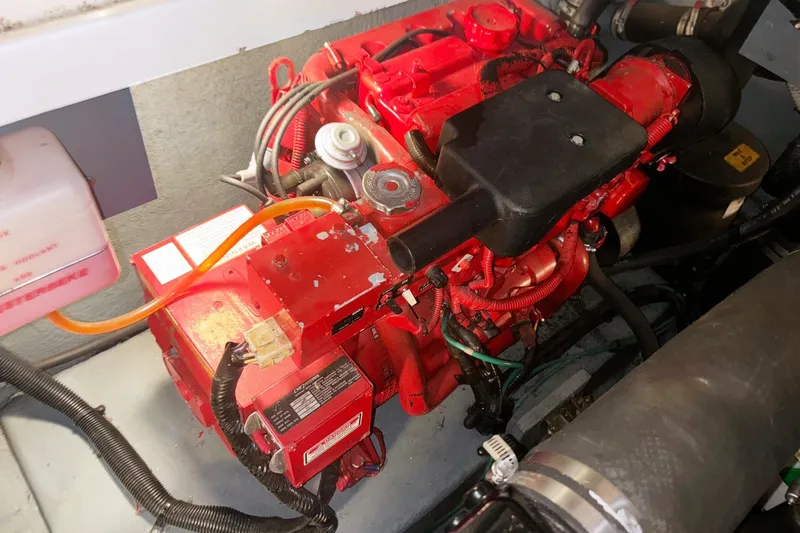 Slide: The Image of Engine compartment of a 2000 Sea Ray 340 Sundancer boat, featuring a red engine. - 21
