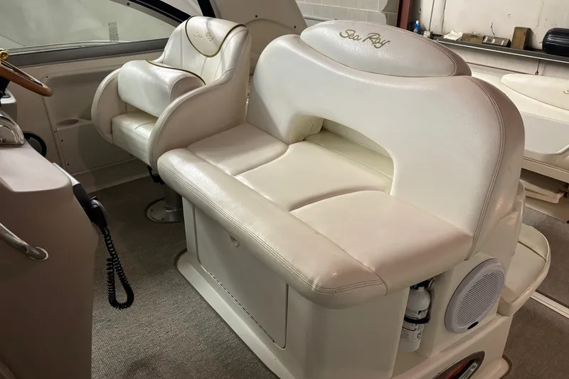 Slide: The Image of Interior seating of a 2000 Sea Ray 340 Sundancer boat, featuring white leather upholstery. - 9