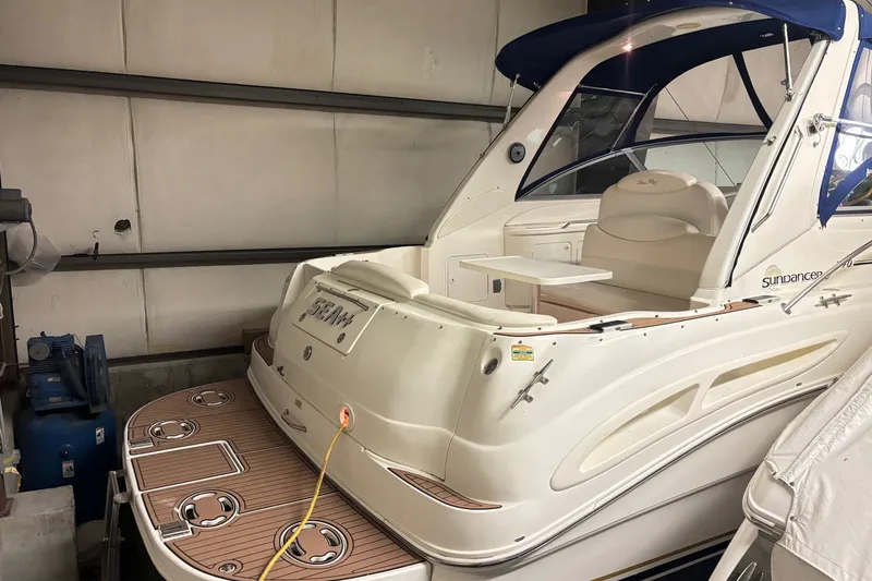 Slide: The Image of 2000 Sea Ray 340 Sundancer yacht in storage, featuring a sleek design and spacious deck. - 3