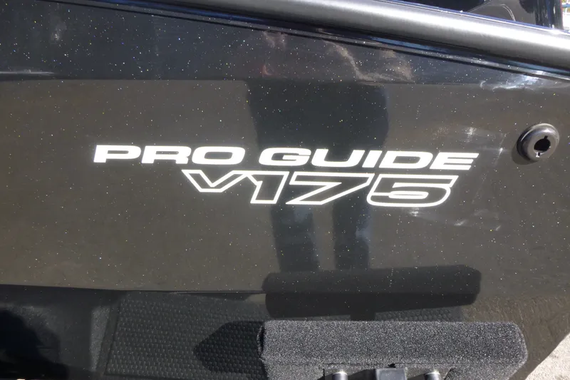 Slide: The Image of 2027 Tracker Pro Guide V-175 WT boat model logo on black surface. - 15