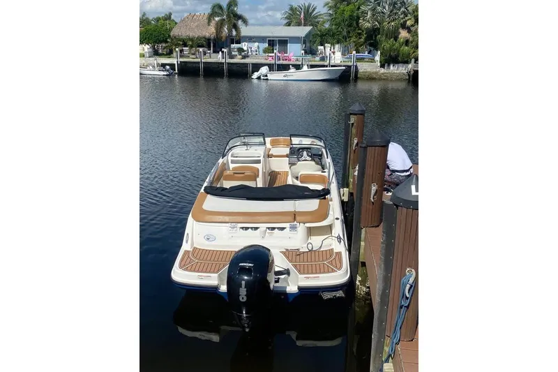 Slide: The Image of 2021 Bayliner VR6 Bowrider OB docked on a calm waterfront. - 4