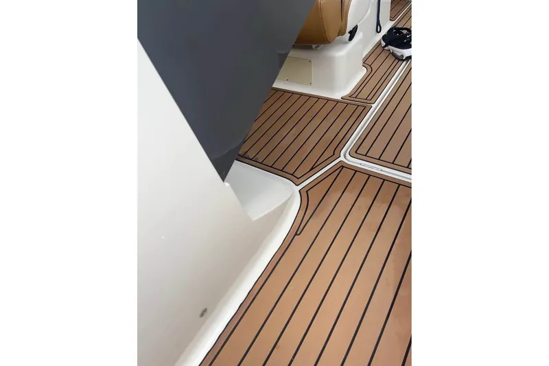 Slide: The Image of 2021 Bayliner VR6 Bowrider OB interior with sleek, modern flooring design. - 13