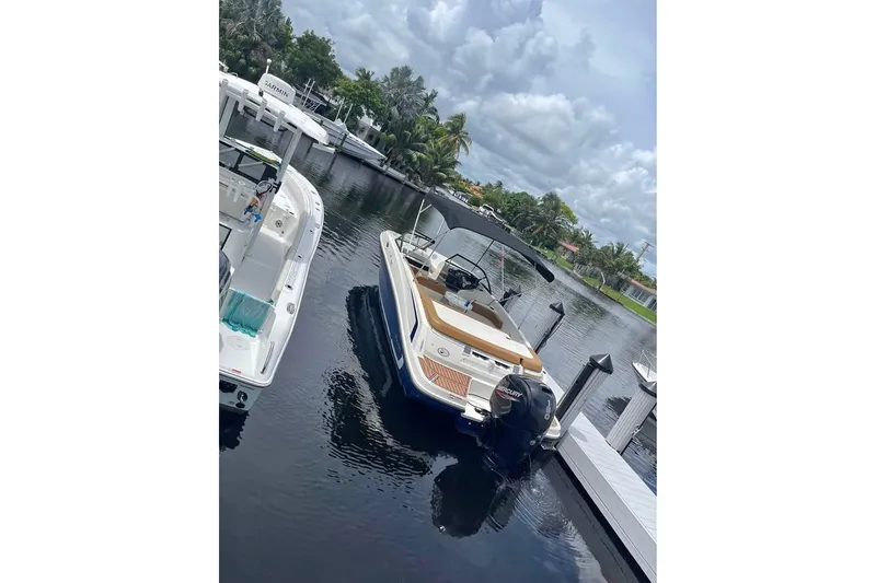 Slide: The Image of 2021 Bayliner VR6 Bowrider OB docked in a scenic marina setting. - 5