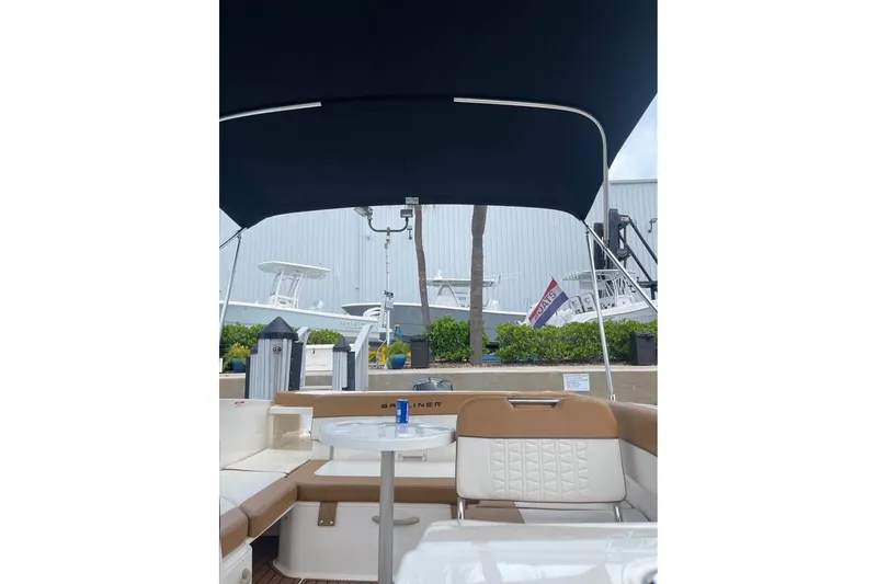 Slide: The Image of 2021 Bayliner VR6 Bowrider OB interior with canopy, showcasing seating and table. - 3