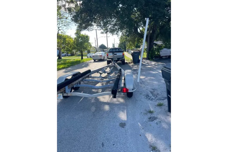 Slide: The Image of Trailer for 2021 Bayliner VR6 Bowrider OB parked on a sunny residential street. - 15
