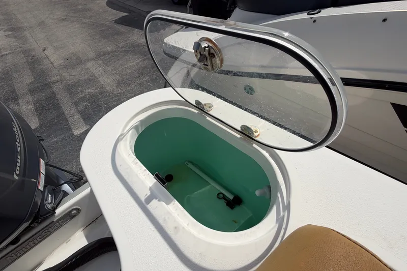 Slide: The Image of Open hatch on 2023 NauticStar 2602 Legacy boat, revealing storage compartment. - 17