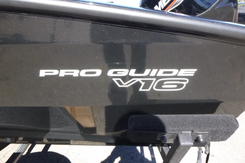 Slide: The Image of 2027 Tracker Pro Guide V-16 WT boat, black exterior with model name displayed. - 14