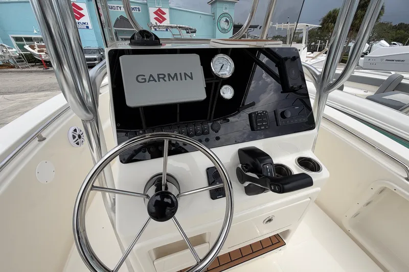 Slide: The Image of 2027 Bulls Bay 200 Center Console boat dashboard with Garmin navigation system and steering wheel. - 6
