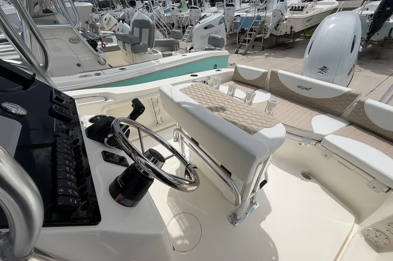 Slide: The Image of 2027 Bulls Bay 200 Center Console boat interior with steering wheel and seating. - 11