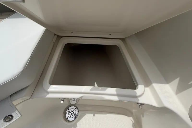 Slide: The Image of 2027 Bulls Bay 200 Center Console boat storage compartment, open and empty. - 13