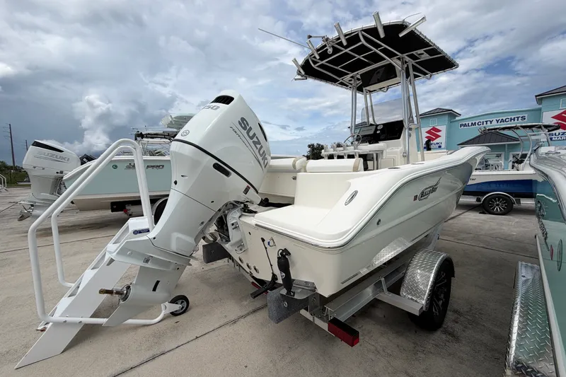 Slide: The Image of 2027 Bulls Bay 200 Center Console boat with Suzuki outboard motor at dealership. - 2