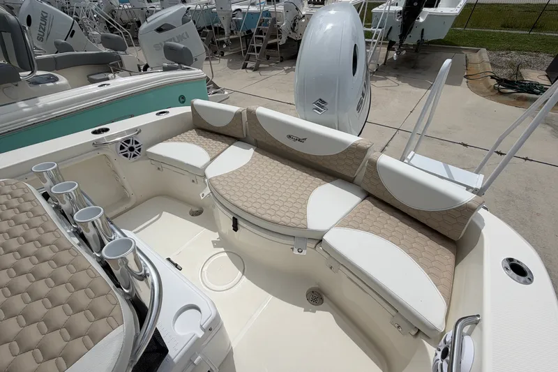 Slide: The Image of 2027 Bulls Bay 200 Center Console boat with beige seating and rod holders. - 12