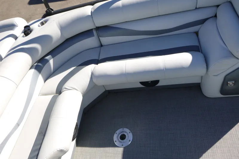 Slide: The Image of Luxurious seating on a 2000 Bennington 2575 boat, featuring plush white upholstery. - 13