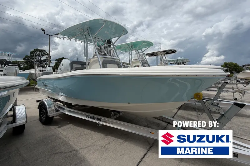 The Image of 2027 Pioneer 202 Sportfish boat on trailer, powered by Suzuki Marine, under cloudy sky. - 0
