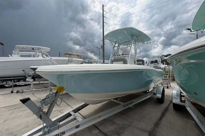 Slide: The Image of 2027 Pioneer 202 Sportfish boat on trailer under cloudy sky. - 1